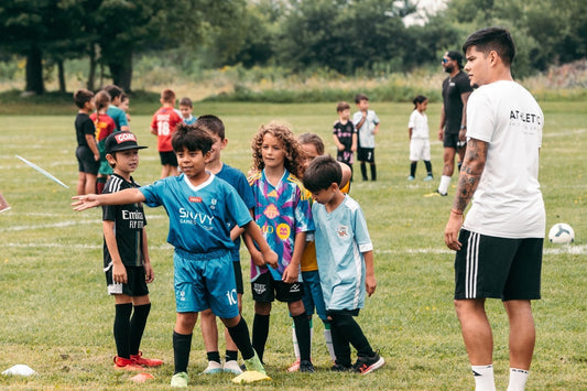 Coach Sebas leading youth football training